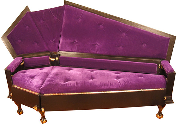 A purple and brown couch that looks like a vampire coffin